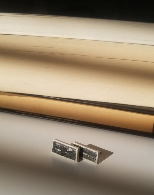 Black printed rectangle studs close up. Handmade porcelain jewelry.