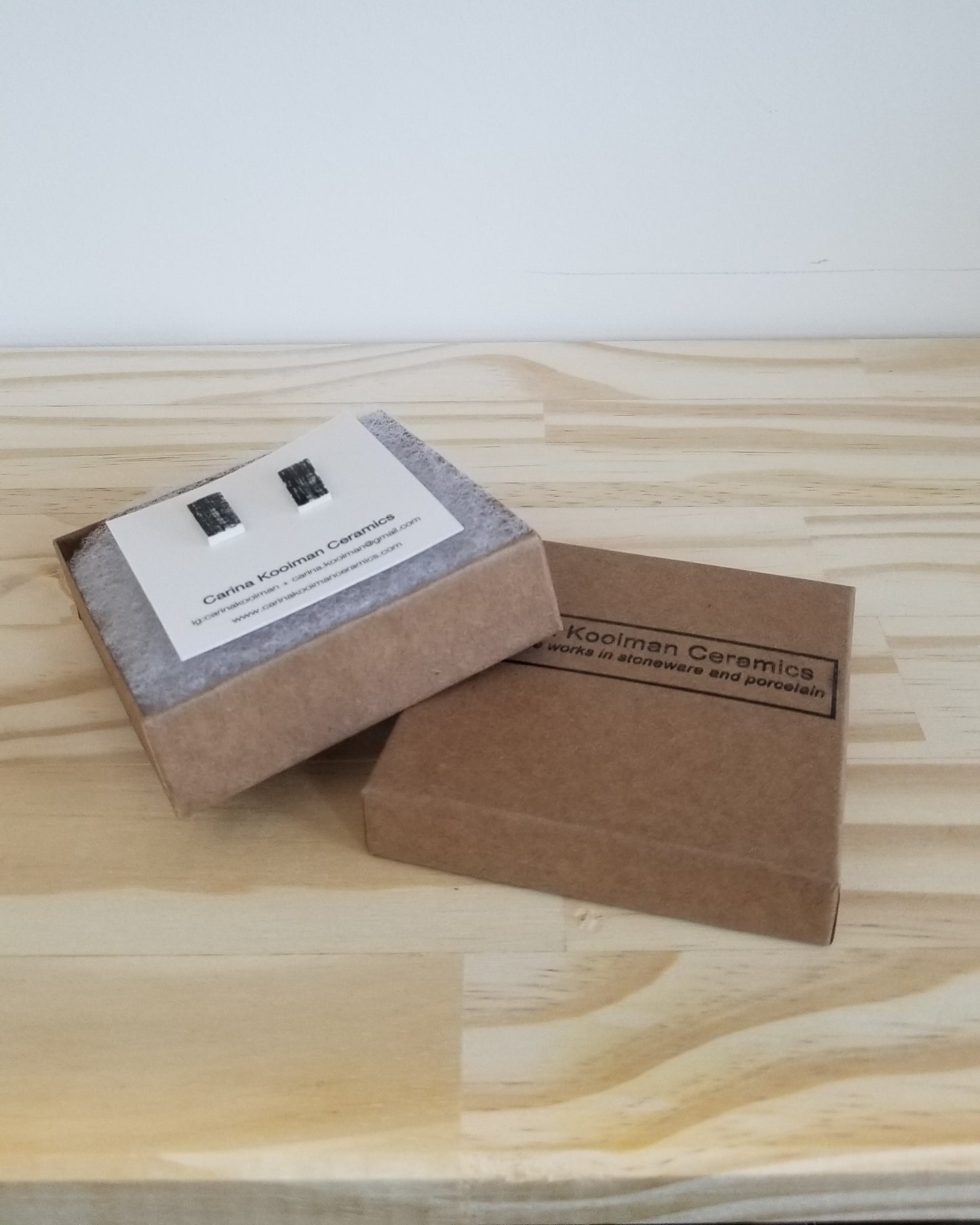 Black printed rectangle studs, with packaging. Handmade porcelain jewelry.
