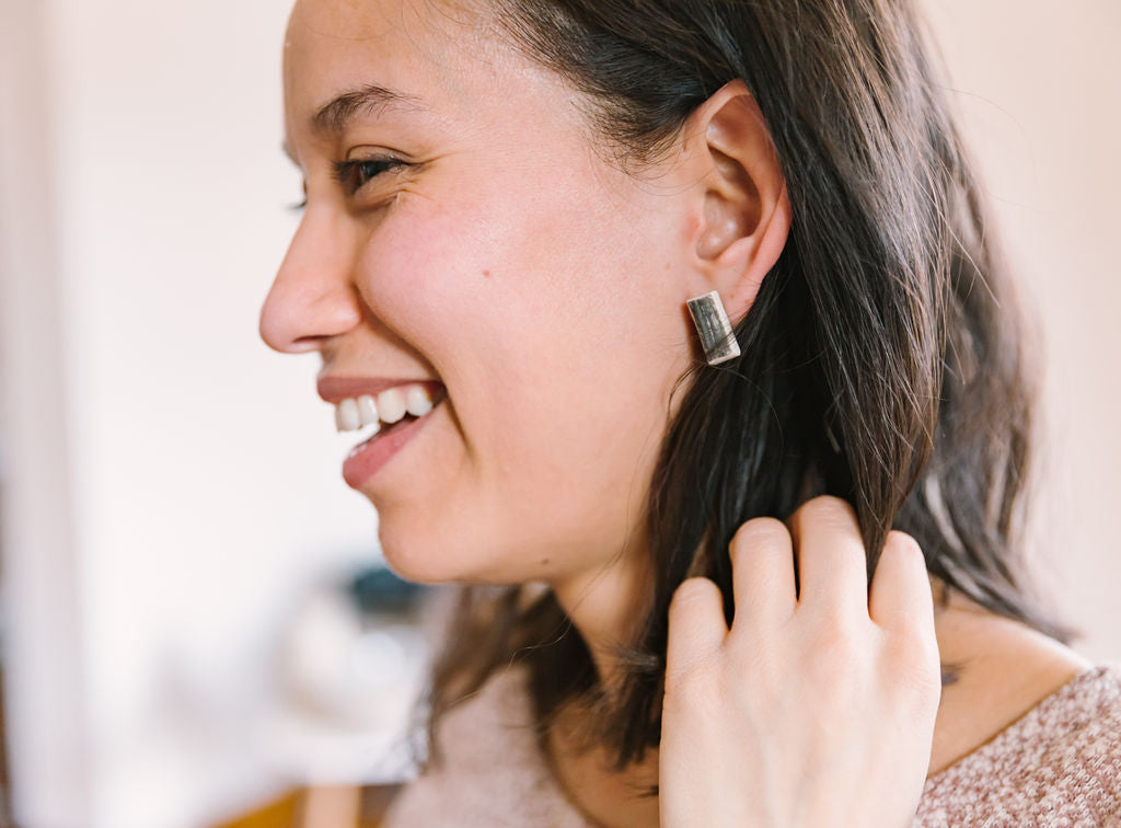 Black printed rectangle studs, lifestyle shot. Handmade porcelain jewelry.